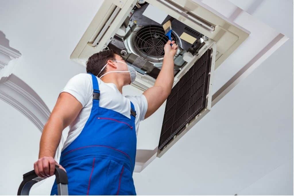 Technician Cleaning Ceiling AC